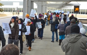 Airport workers and their supporters march outside Terminal 1 at Minneapolis-St. Paul International Airport during a week of action targeting low-wage employers.