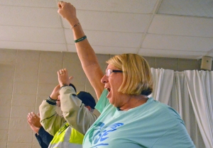 AFSCME volunteer Sheila Pokorny lets out a cheer.